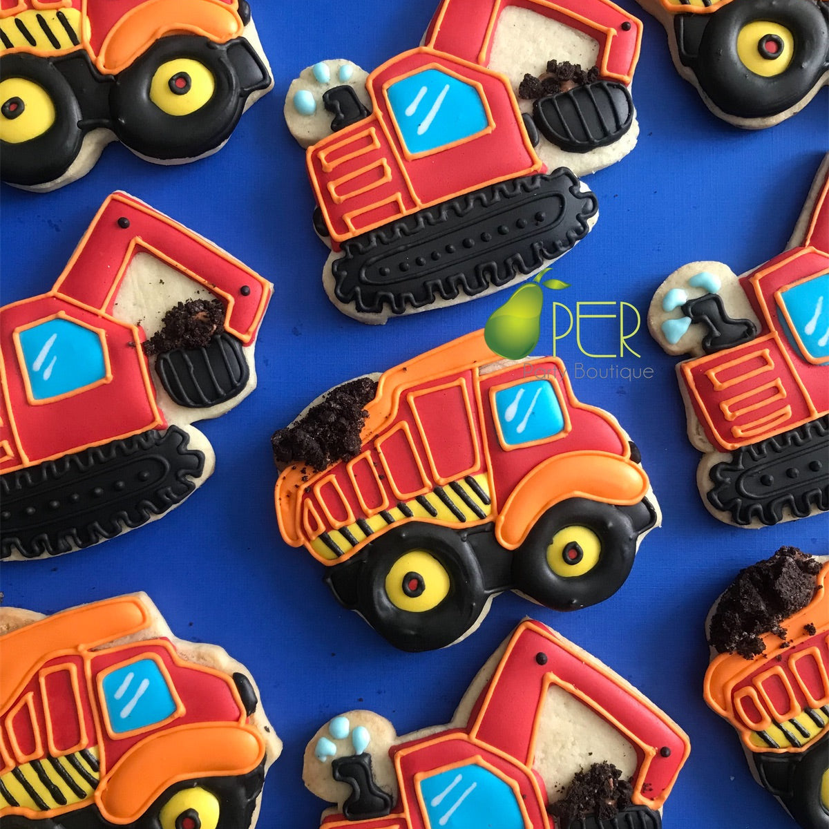 Construction vehicle-themed cookies on a blue background