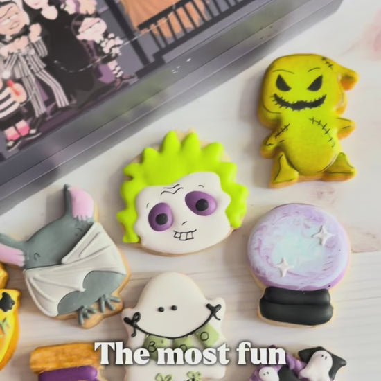 halloween cookie advent countdown calendar, a video shocasing the calendar box that has 12 windows and 12 assorted halloween decorated mini cookies