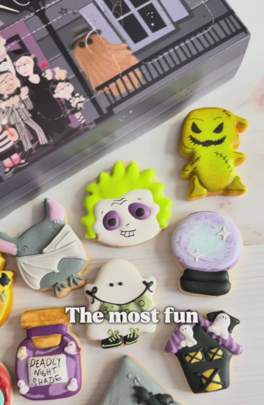 halloween cookie advent countdown calendar, a video shocasing the calendar box that has 12 windows and 12 assorted halloween decorated mini cookies